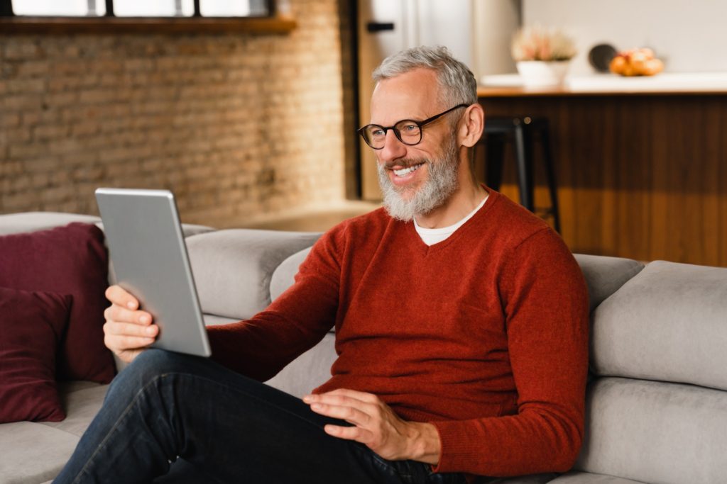 Videocall conference meeting online. Man talking on tablet with colleagues, friends, relatives